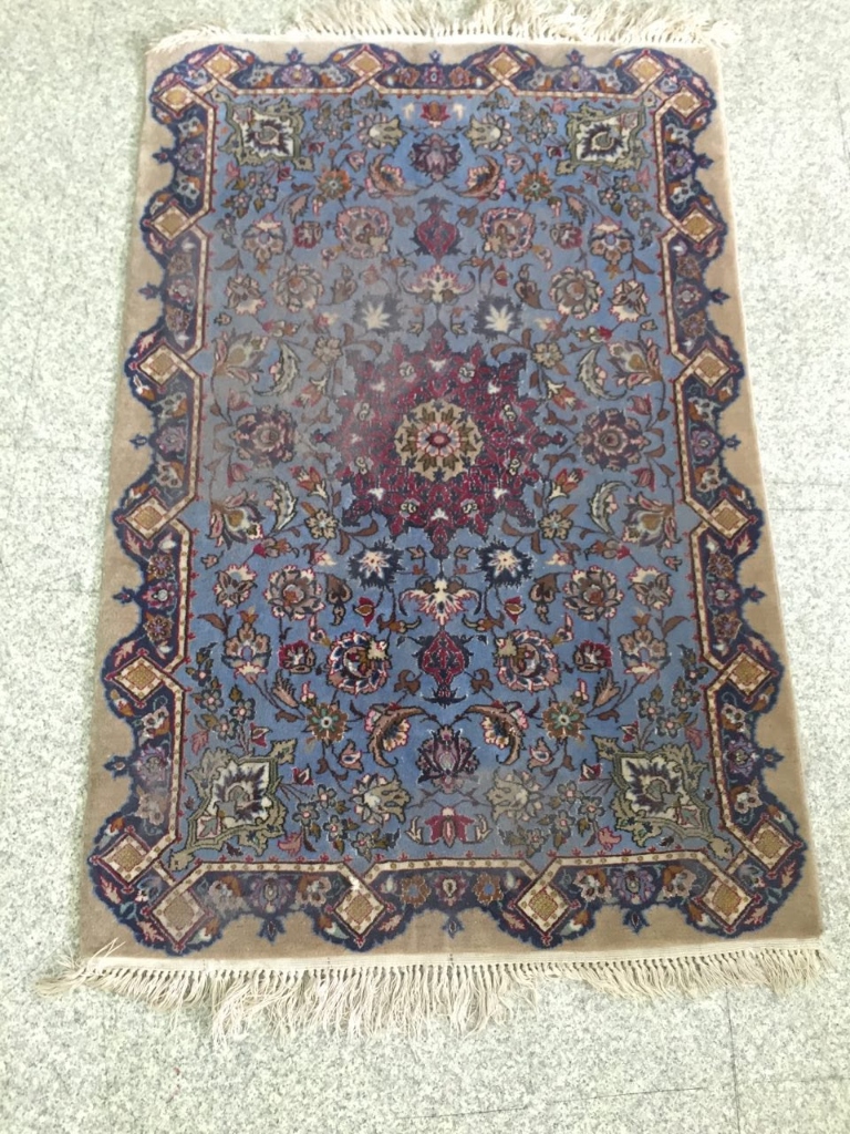 Dull and faded blue Kashan rug before shearing