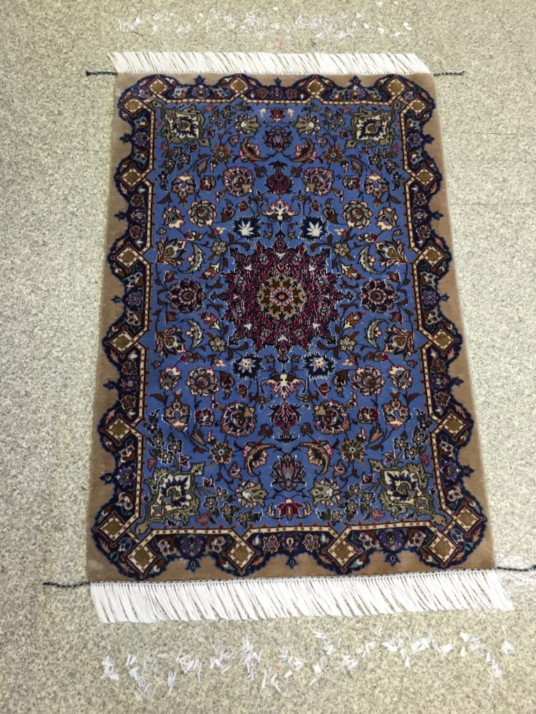 Clean, bright blue Kashan rug completed